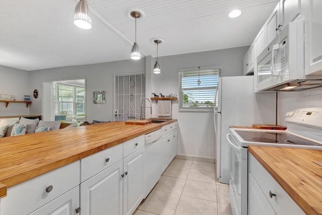 kitchen with hanging light fixtures, white cabinetry, white appliances, and wood counters