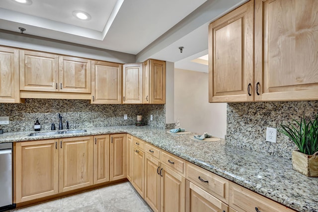 kitchen with tasteful backsplash, dishwasher, sink, and light stone counters