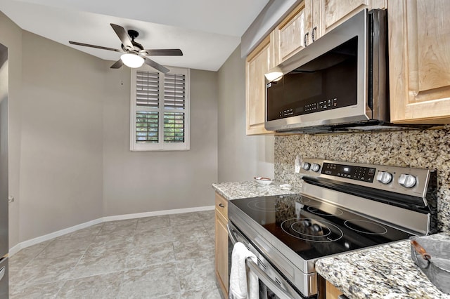 kitchen with tasteful backsplash, appliances with stainless steel finishes, light brown cabinetry, and light stone countertops