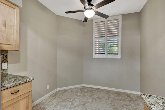 interior space featuring light tile patterned floors and ceiling fan