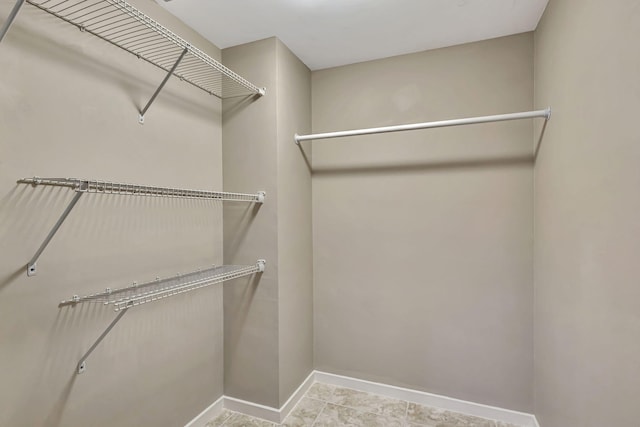11370 Twelve Oaks Way Unit 217, North Palm Beach, FL 33408 - spacious closet featuring tile patterned floors
