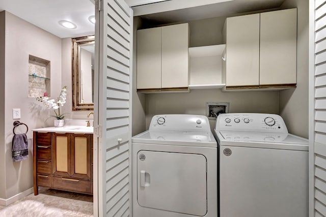 11370 Twelve Oaks Way Unit 217, North Palm Beach, FL 33408 - laundry room featuring washer and clothes dryer, cabinet space, and baseboards