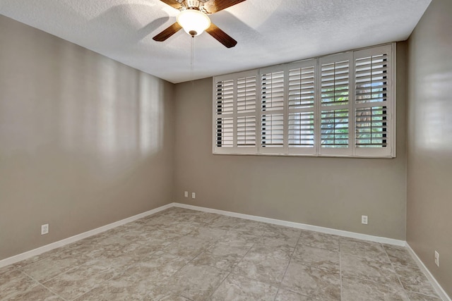 empty room featuring ceiling fan and a textured ceiling