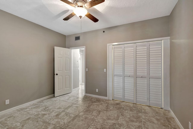 unfurnished bedroom with ceiling fan, a closet, and a textured ceiling