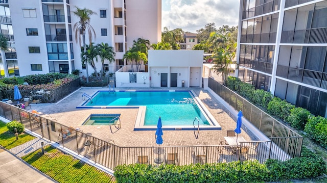 view of pool featuring a hot tub and a patio area