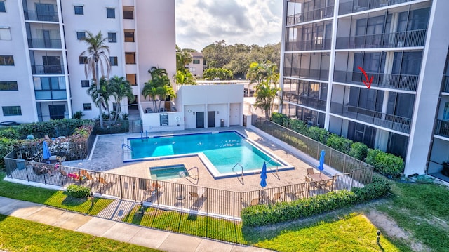 view of swimming pool featuring a patio area and a hot tub