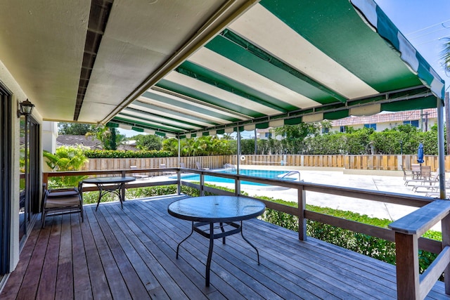 wooden terrace with a fenced in pool