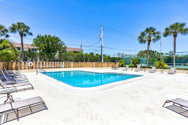 view of swimming pool with a patio area