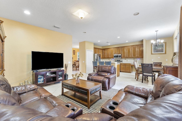 living room with light tile patterned floors and a chandelier