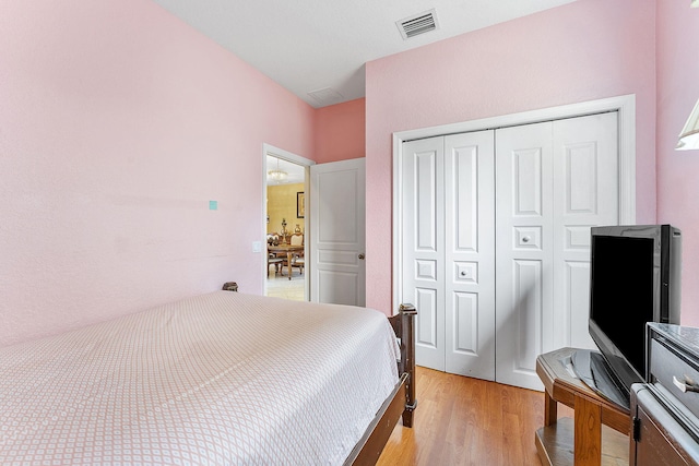 bedroom with a closet and light hardwood / wood-style flooring