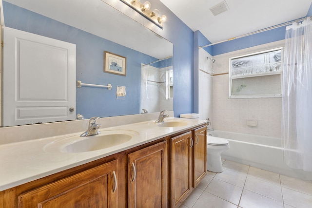 full bathroom featuring tile patterned floors, vanity, toilet, and shower / tub combo