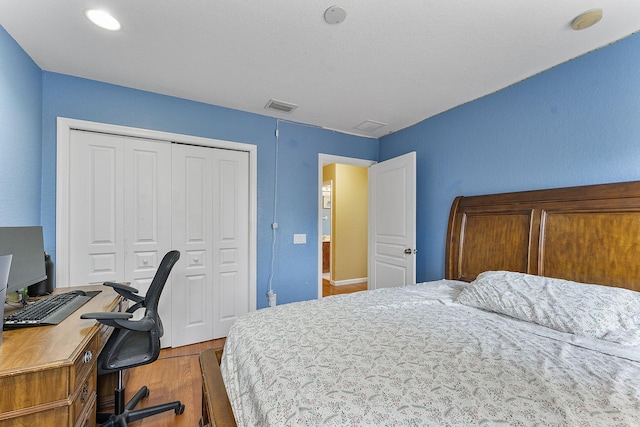 bedroom with hardwood / wood-style floors and a closet