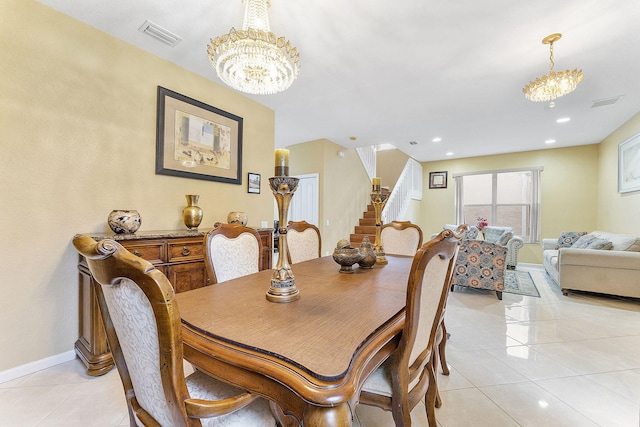 tiled dining area with an inviting chandelier