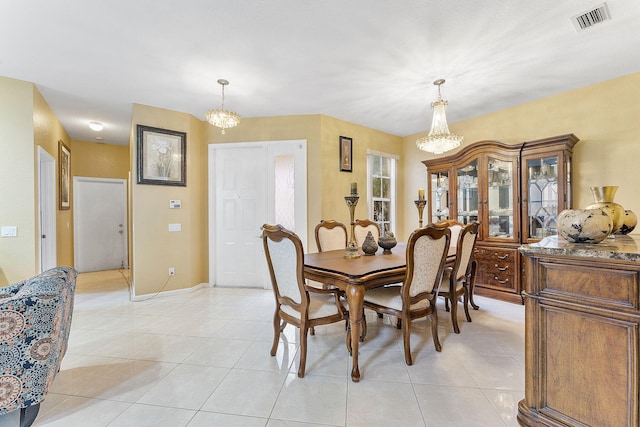 dining room with an inviting chandelier and light tile patterned floors