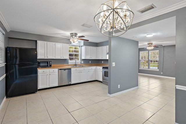 kitchen featuring sink, a wealth of natural light, pendant lighting, stainless steel appliances, and white cabinets