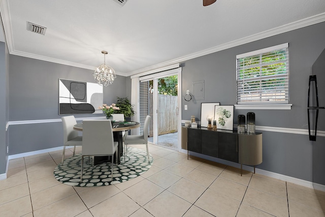 tiled dining area with ornamental molding, a wealth of natural light, and a notable chandelier