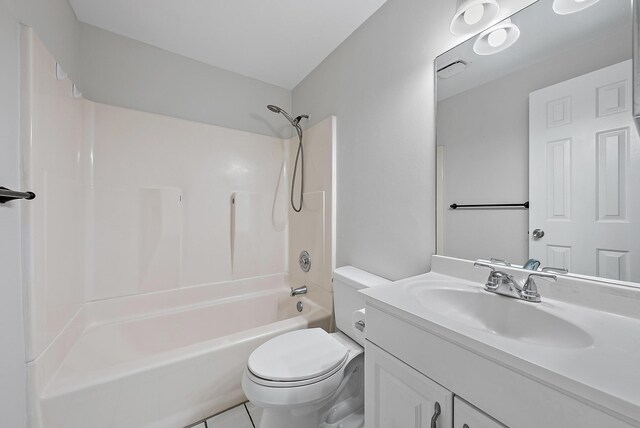 full bathroom featuring toilet, tile patterned floors, vanity, and bathtub / shower combination