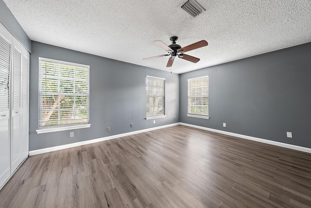 unfurnished room with ceiling fan, light hardwood / wood-style flooring, and a textured ceiling