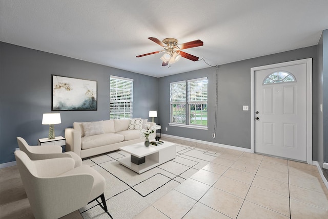 living room with light tile patterned floors, a textured ceiling, and ceiling fan