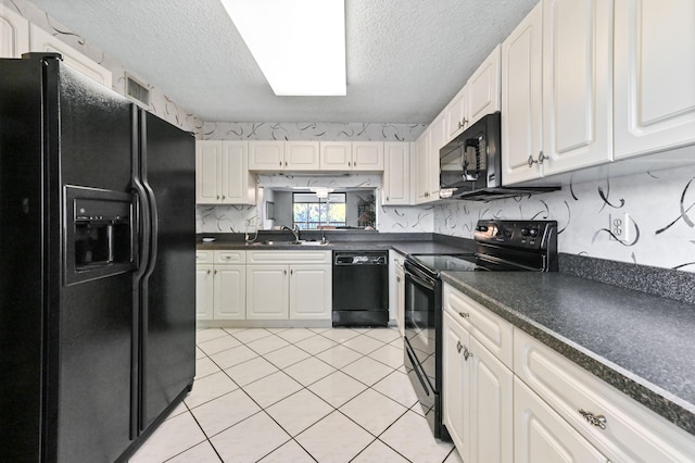 kitchen with white cabinetry, sink, black appliances, and a textured ceiling