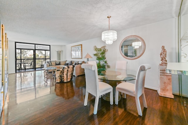 dining room featuring a chandelier, a textured ceiling, and dark hardwood / wood-style flooring