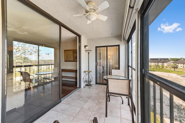 sunroom / solarium featuring ceiling fan