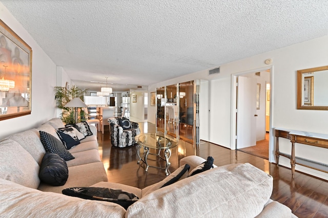 living room with hardwood / wood-style floors and a textured ceiling