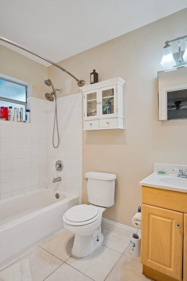 full bathroom with tile patterned floors, toilet, tiled shower / bath combo, and vanity