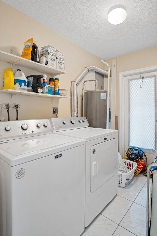 laundry room featuring independent washer and dryer, water heater, and a textured ceiling