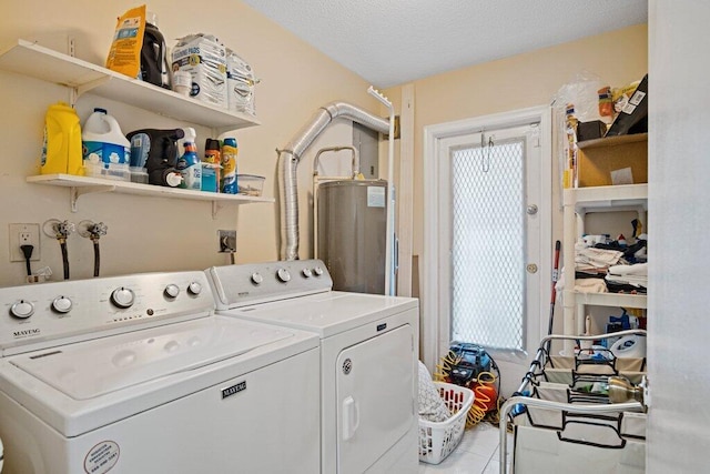 laundry room with light tile patterned floors, washing machine and dryer, a textured ceiling, and gas water heater