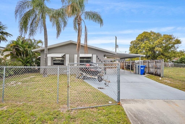 view of front facade with a front yard and a carport