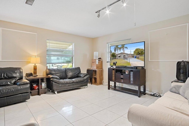 tiled living room featuring rail lighting