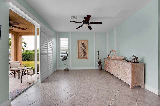 interior space with ceiling fan and tile patterned flooring