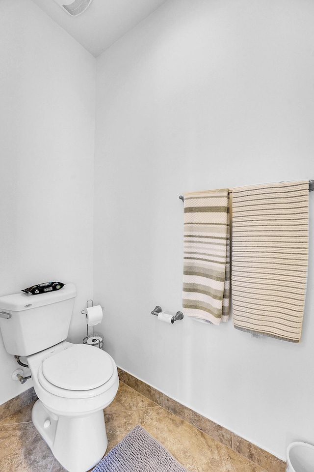 bathroom with tile patterned floors and toilet