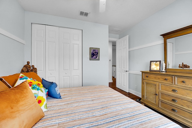 bedroom featuring dark hardwood / wood-style floors, a closet, and ceiling fan