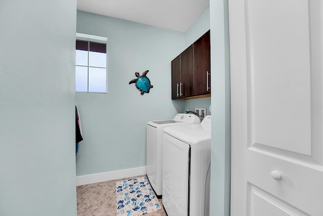 laundry area featuring independent washer and dryer, cabinets, and light tile patterned floors