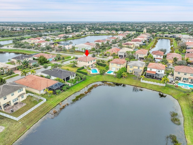 birds eye view of property with a water view