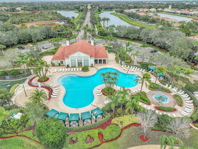 view of pool with a water view, a patio, and french doors