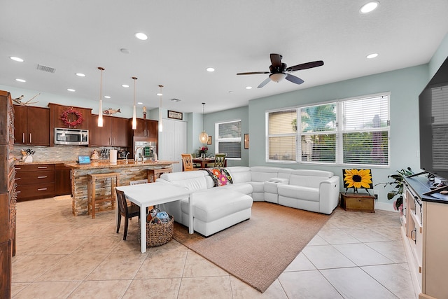 tiled living room featuring ceiling fan