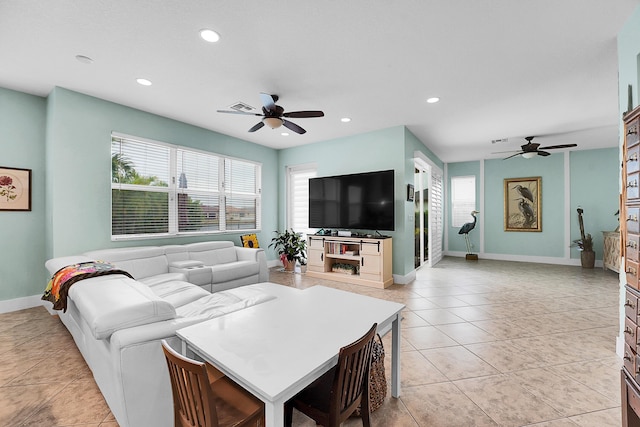 living room featuring ceiling fan and light tile patterned floors