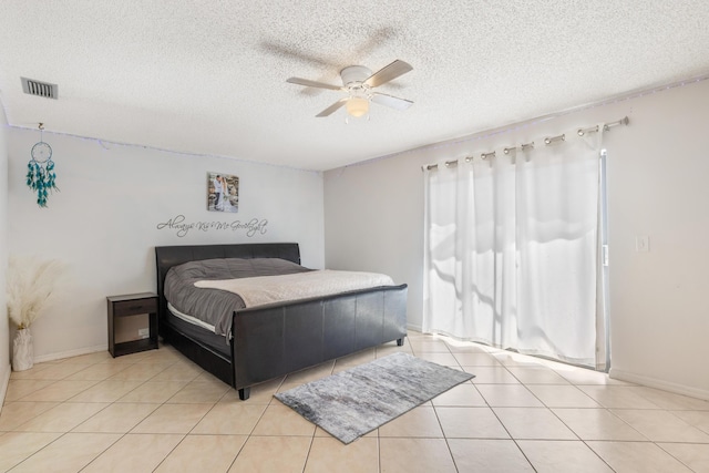 bedroom featuring visible vents, a ceiling fan, light tile patterned flooring, and a textured ceiling