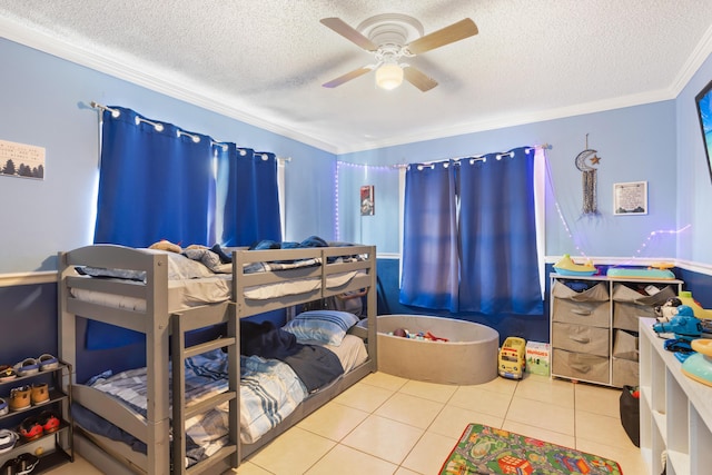 tiled bedroom featuring crown molding, ceiling fan, and a textured ceiling