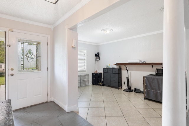 foyer featuring ornamental molding, baseboards, plenty of natural light, and a textured ceiling