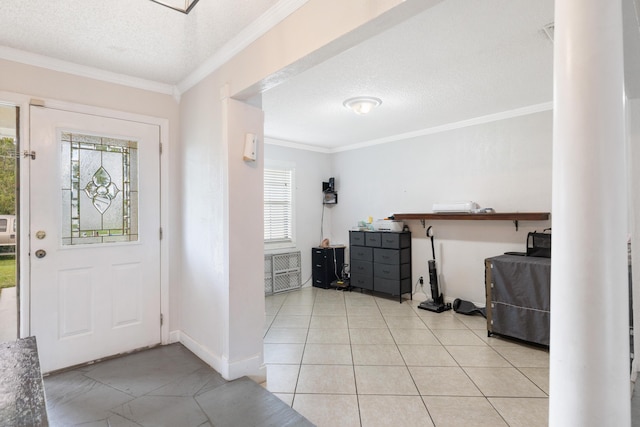 tiled entryway with ornamental molding and a textured ceiling