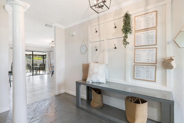 mudroom with a notable chandelier, crown molding, decorative columns, and a textured ceiling