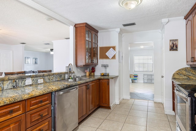 kitchen featuring light tile patterned flooring, sink, crown molding, dark stone countertops, and stainless steel appliances