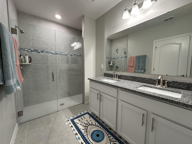 bathroom featuring vanity, tile patterned flooring, and a shower with door