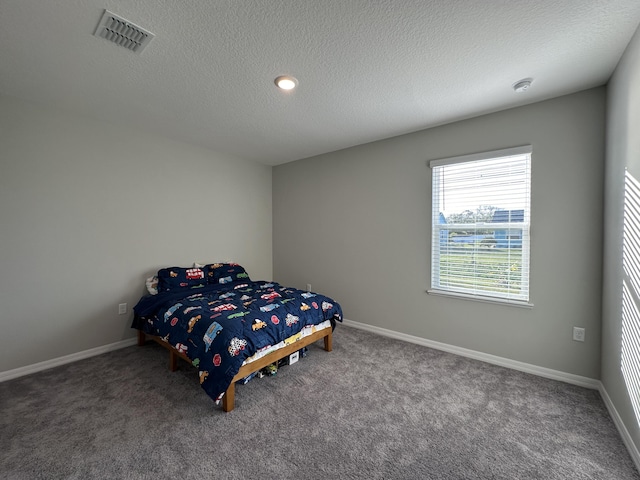 bedroom with carpet flooring and a textured ceiling