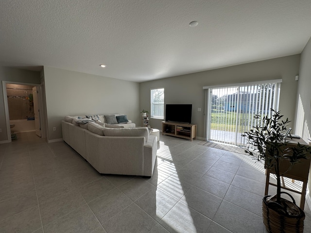 living room with light tile patterned floors and a textured ceiling