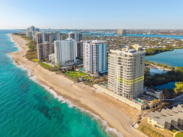 drone / aerial view with a water view and a beach view